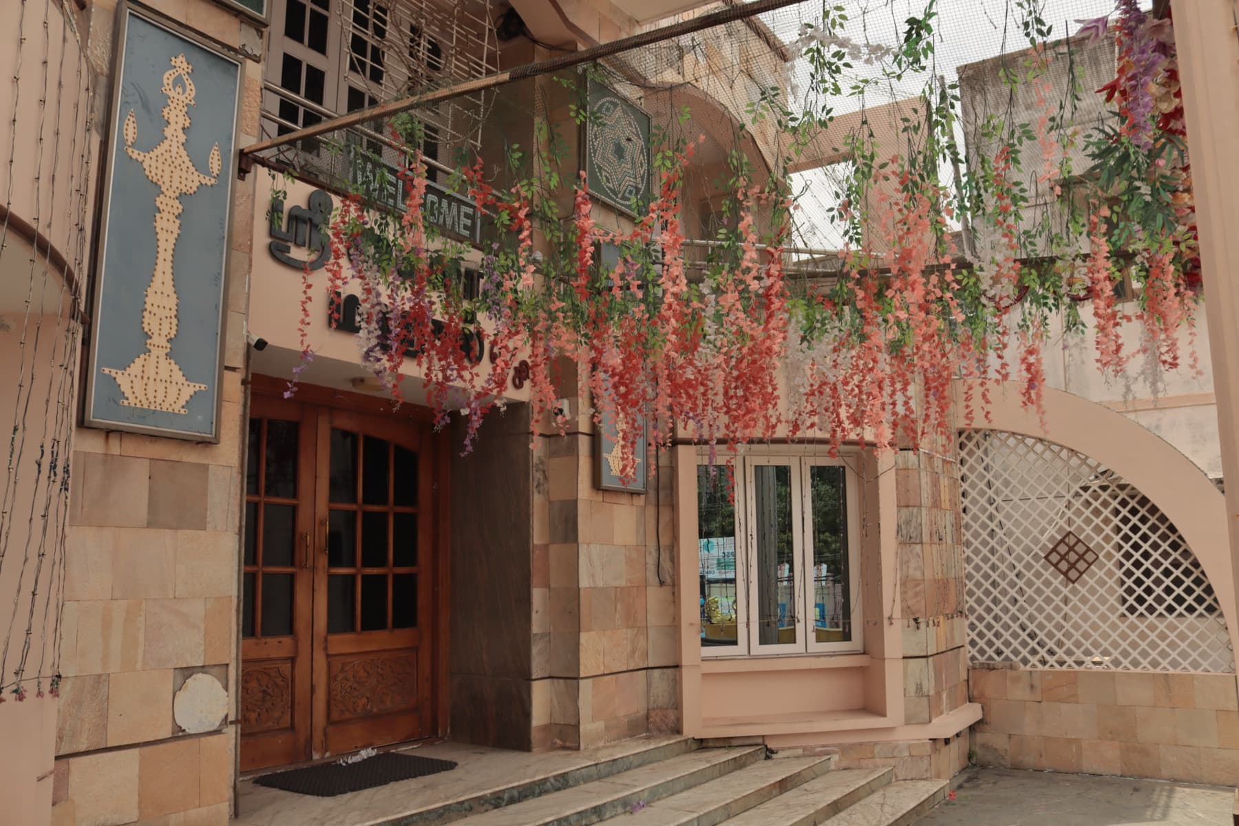 Mahal entrance doors decorated with hanging floral strings