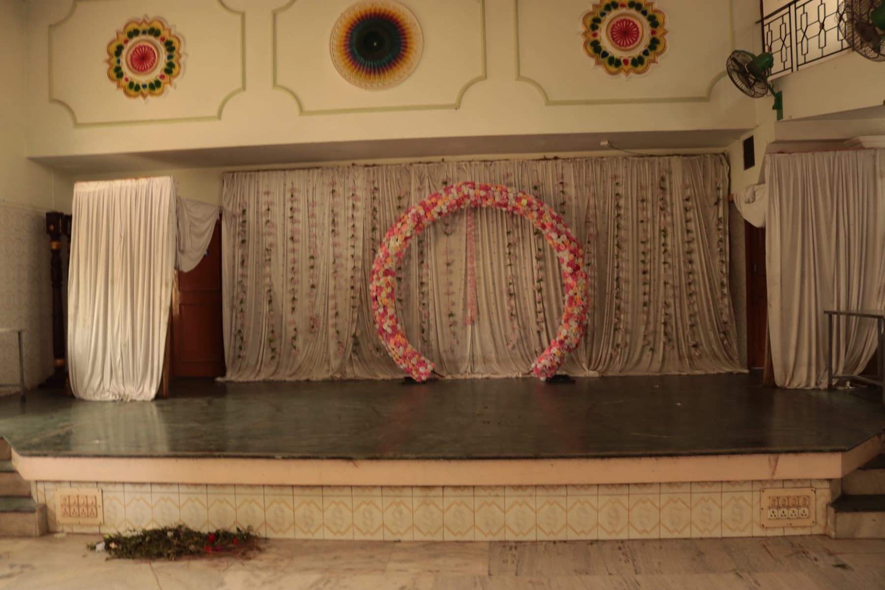 Main Hall stage with floral arch backdrop