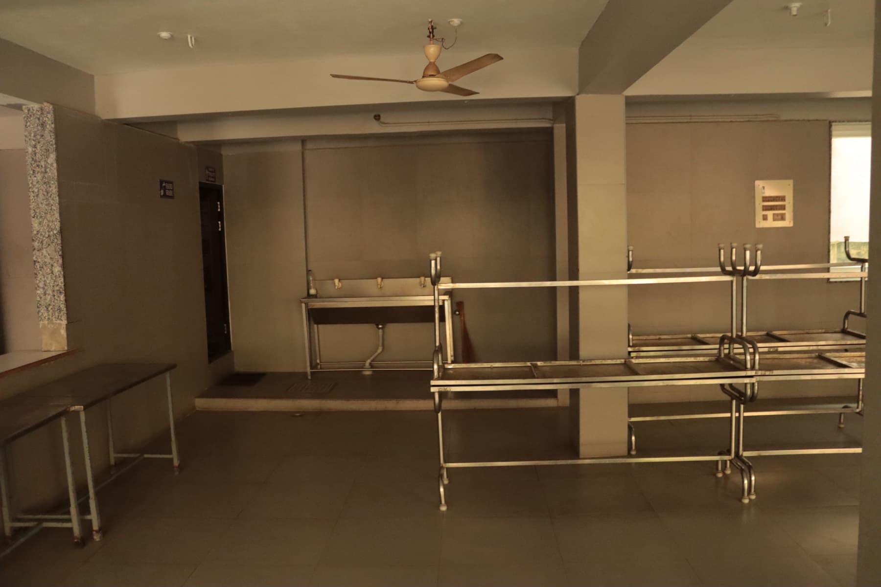 Serving area with steel counters next to the dining hall