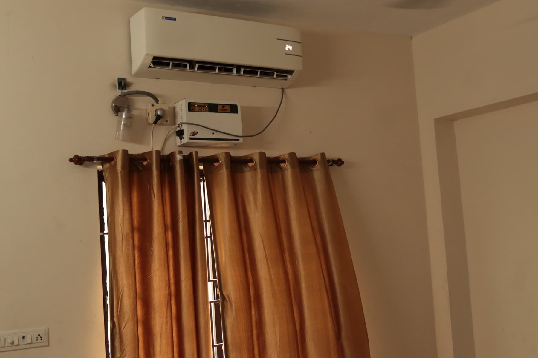 Air conditioning unit and curtained window in the Deluxe AC Double Room