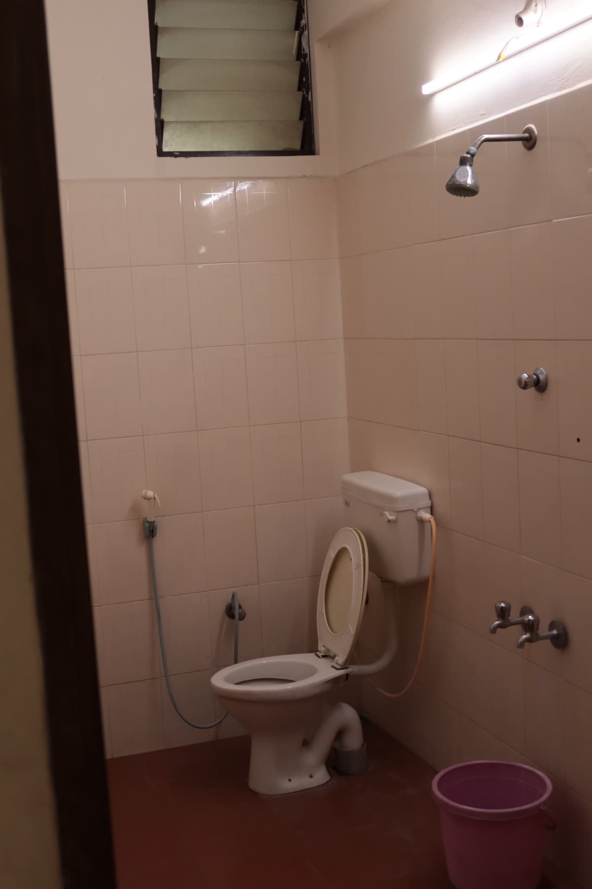 Attached bathroom with Western toilet and shower