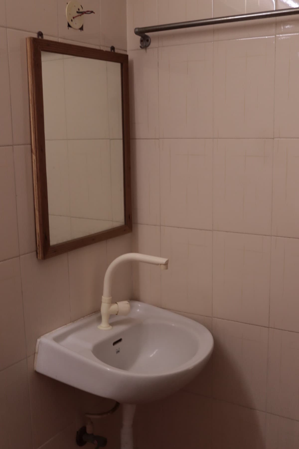 Bathroom washbasin with mirror and towel rail