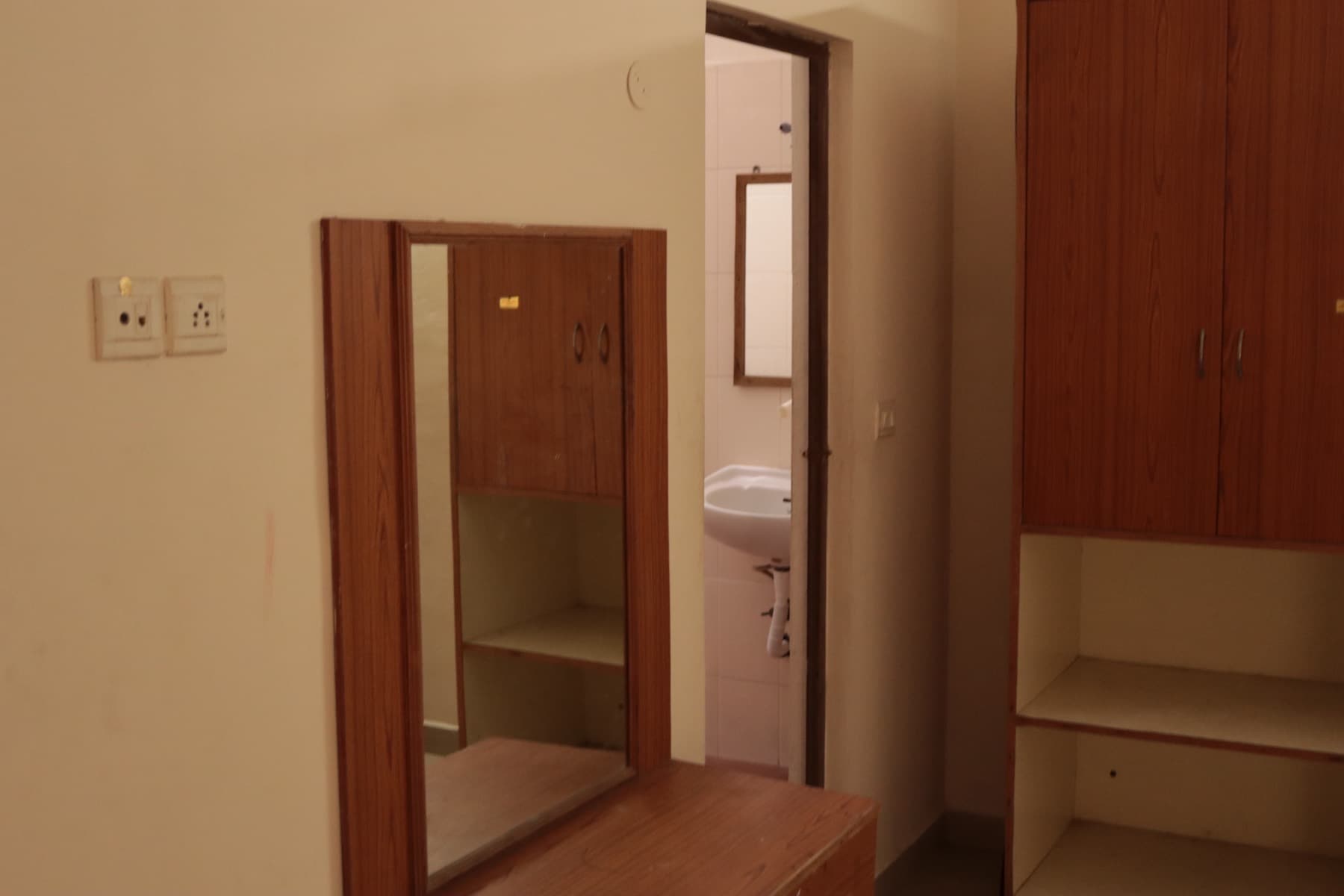 Mirror, wardrobe and attached bathroom doorway