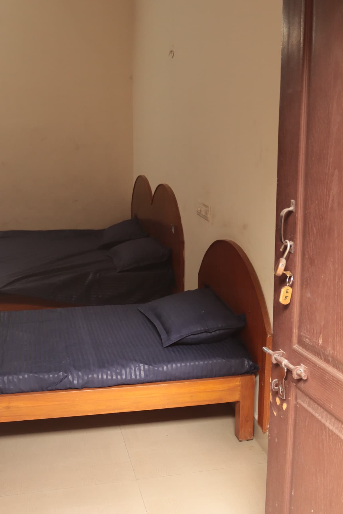Single beds in the Deluxe AC Triple Room
