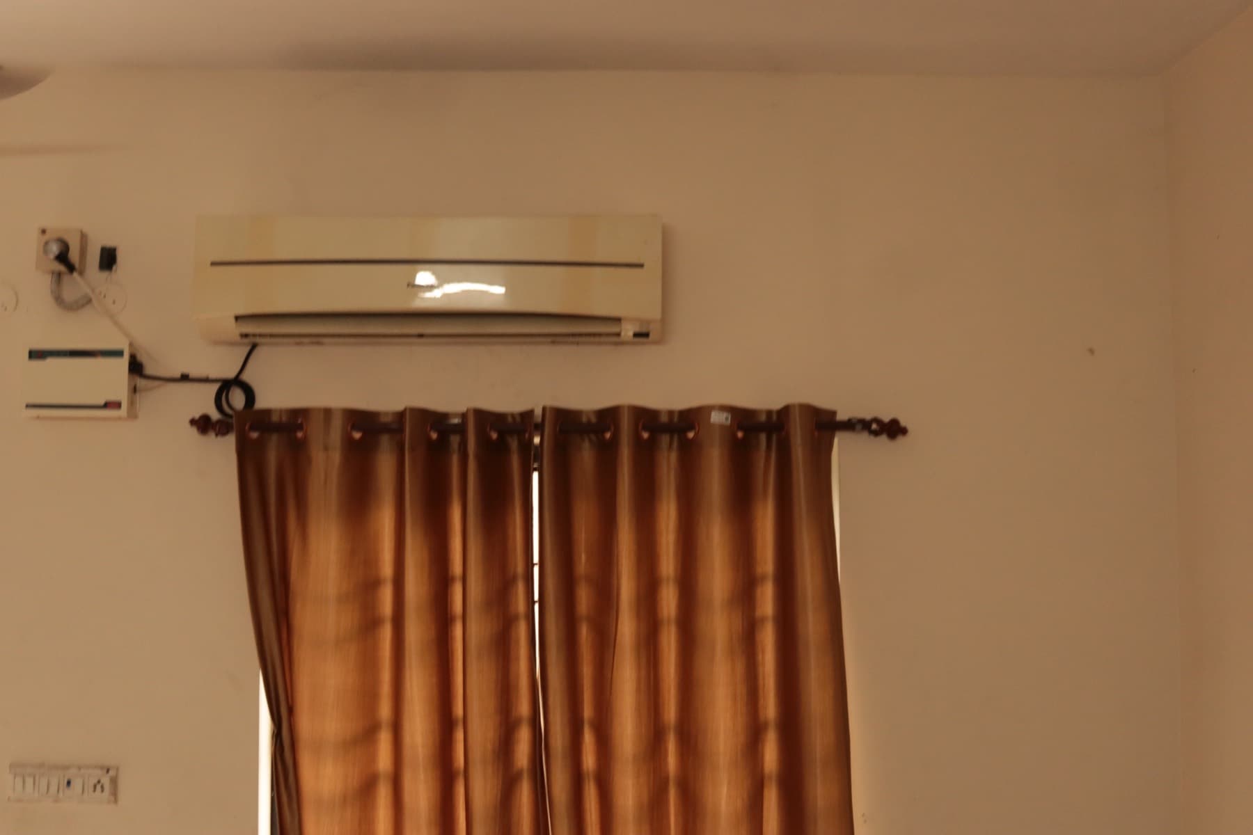 Air conditioning unit and curtained window in the Deluxe AC Triple Room